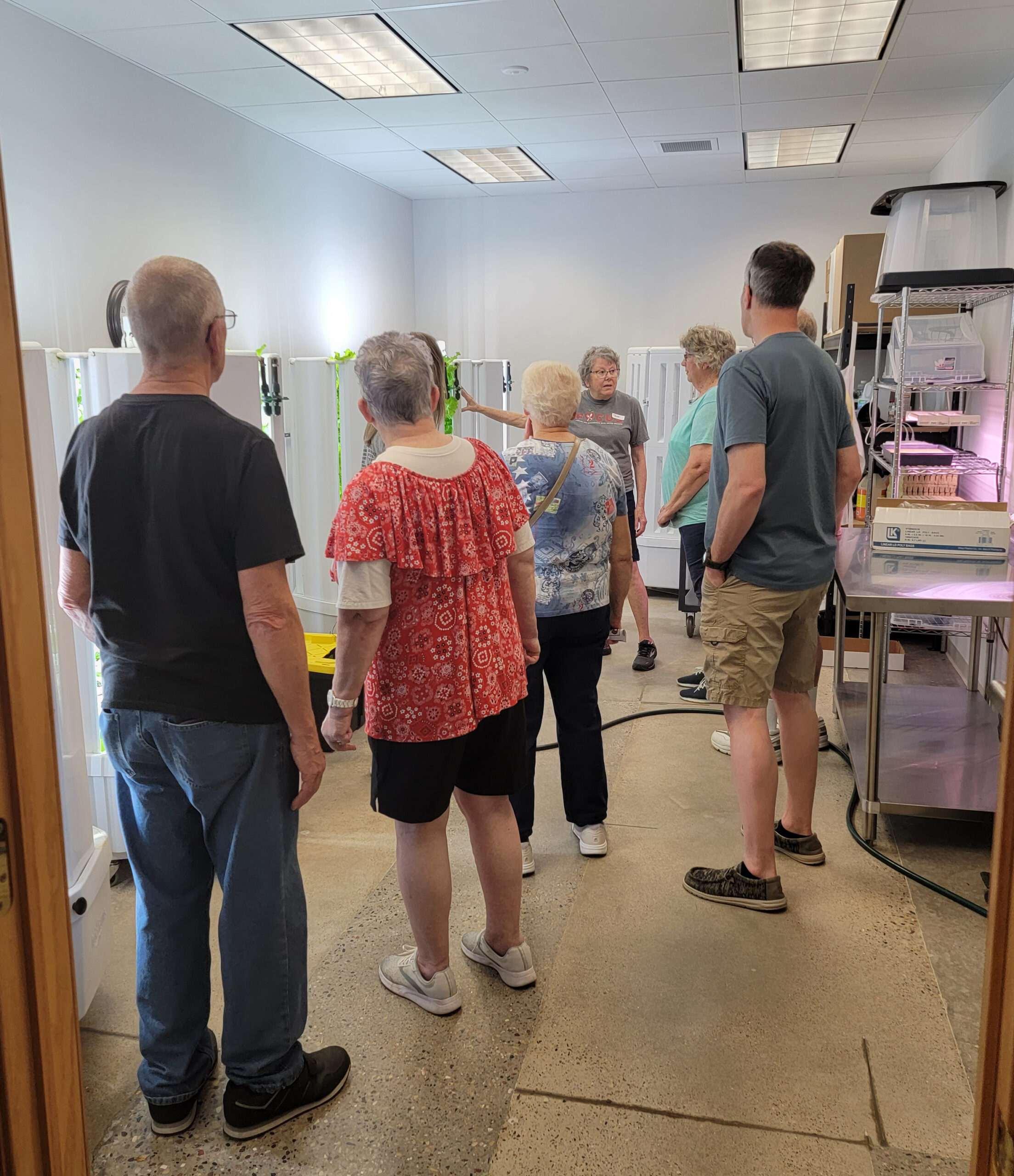 Open House - touring guests learn about the hydroponics system that grows mainly lettuce for the FOCUS Food Pantry.