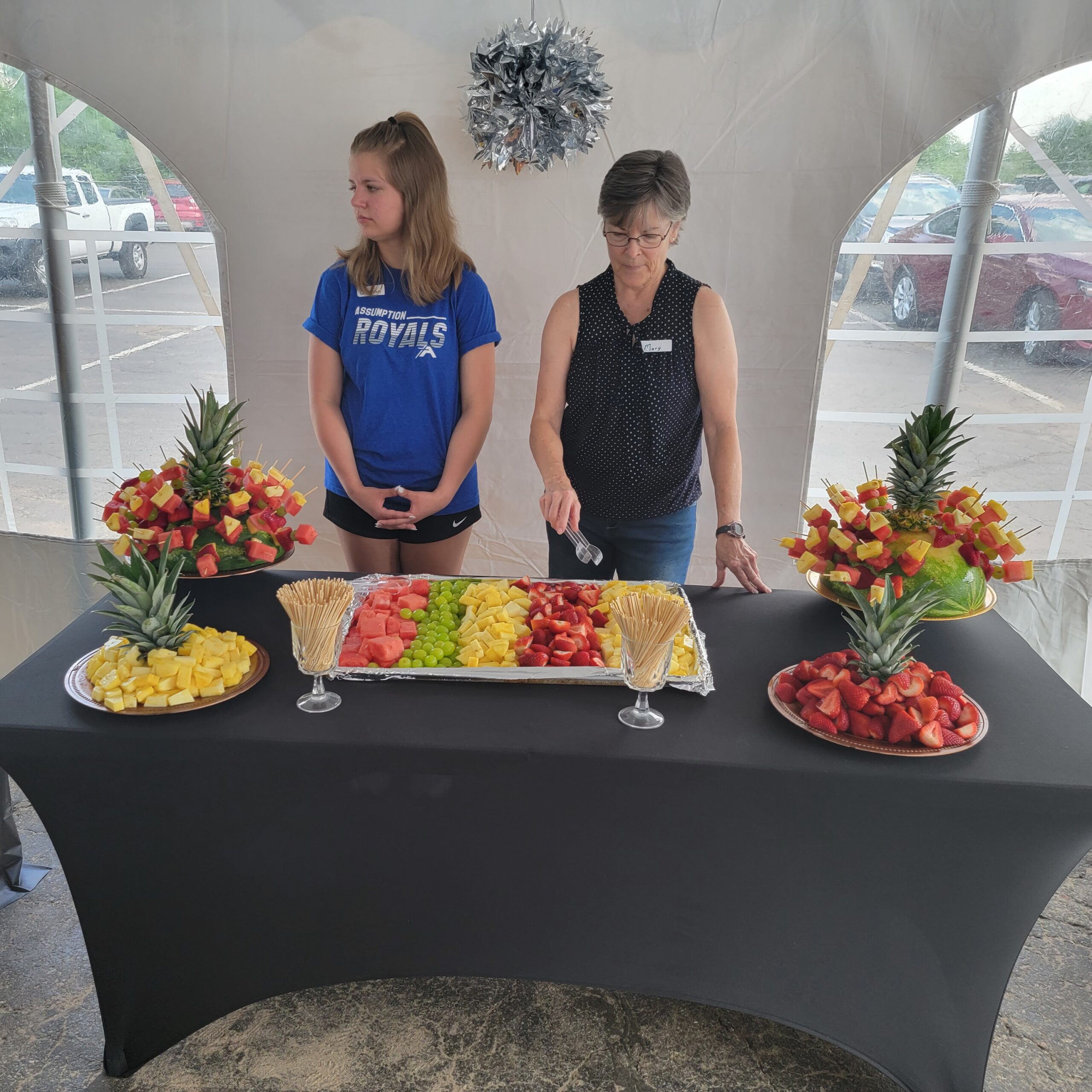 Open House Volunteers serving fruit.