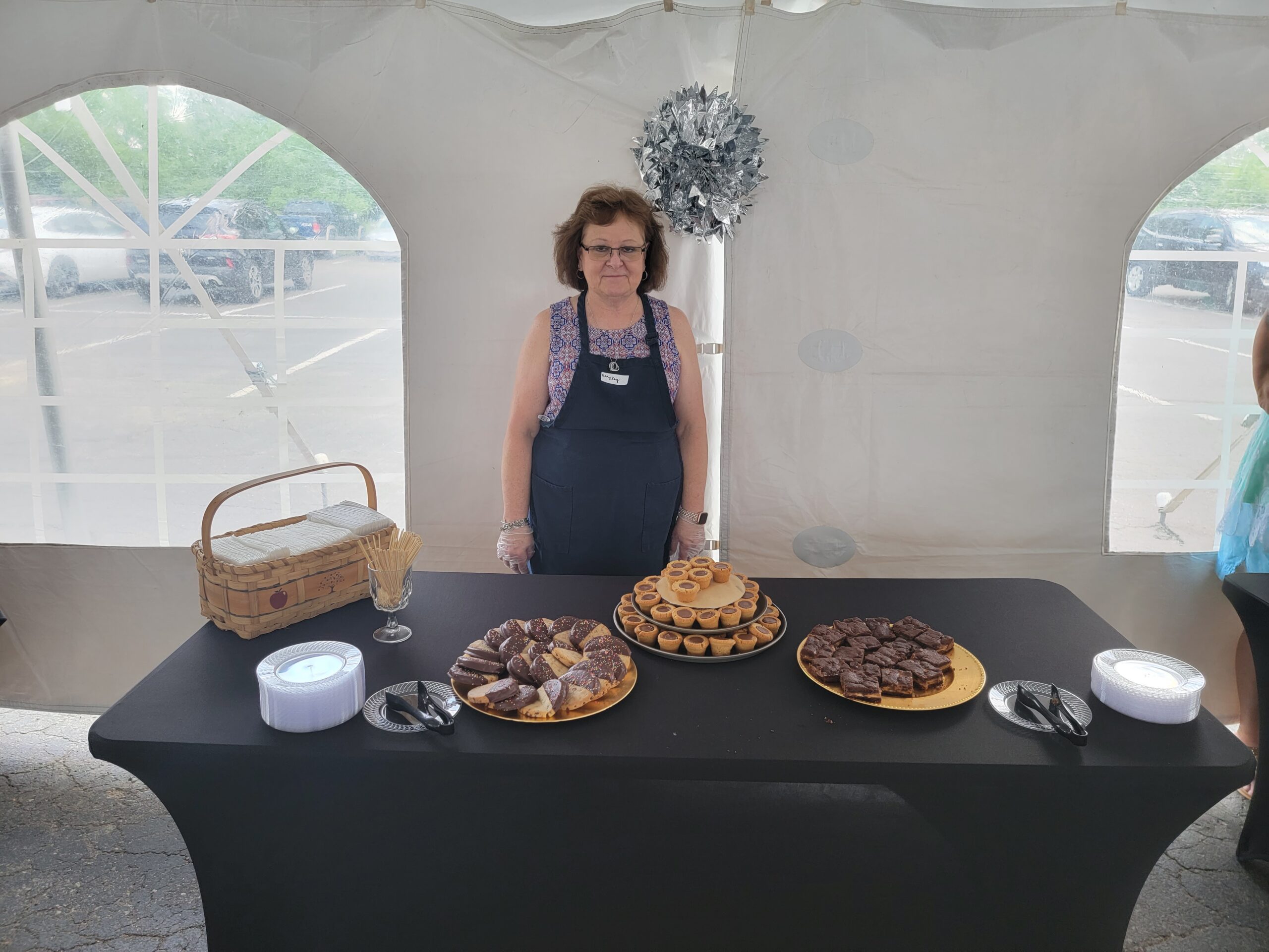 Open House volunteer serves up desserts.