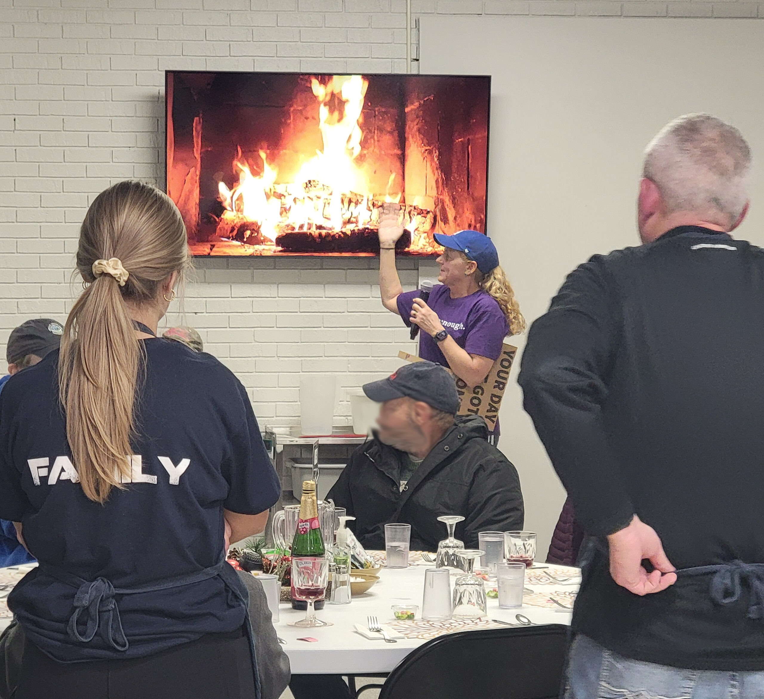 21st Anniversary Meal - Meal Coordinator Dawn Tammen speaks to guests about the special meal in store for them tonight. She also points out the new monitors and speaker system to improve communications with our guests.